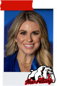 Portrait of a smiling blonde woman in a blue blouse against a blue backdrop; New Albany logo overlays the bottom-right corner.